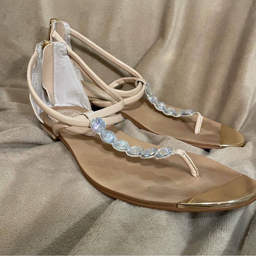 Isola Nude Crystal T-Strap Sandals with Gold Toe Caps.